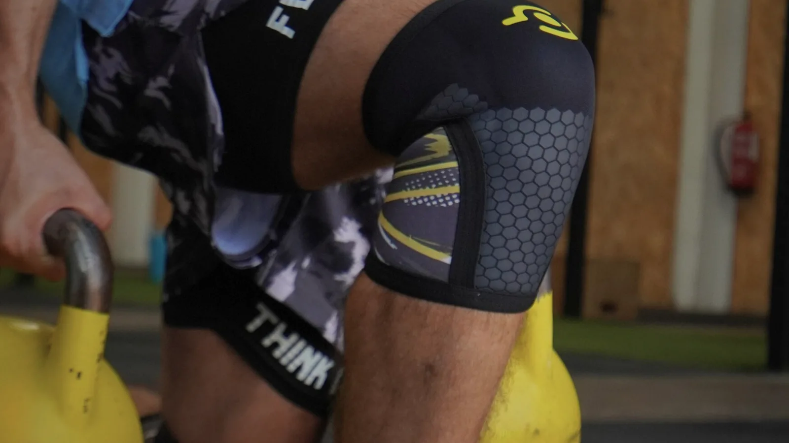 Rodilleras de CrossFit 7 mm THEYET durante entrenamiento con kettlebell.